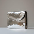 Metallic silver clutch